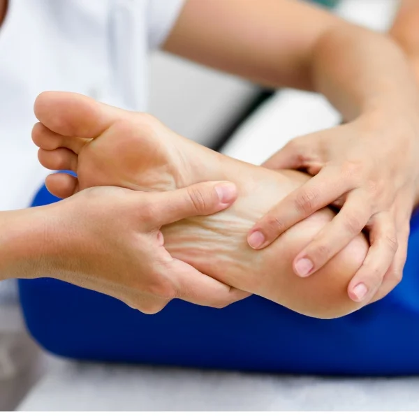 Une personne recevant un massage des pieds dans un cadre relaxant.