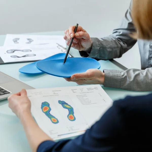 Une femme utilise une assiette en plastique bleue pour mesurer son pied.