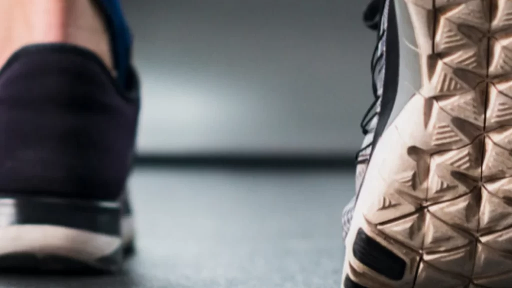 Gros plan sur les pieds d'une personne courant sur un tapis de course.